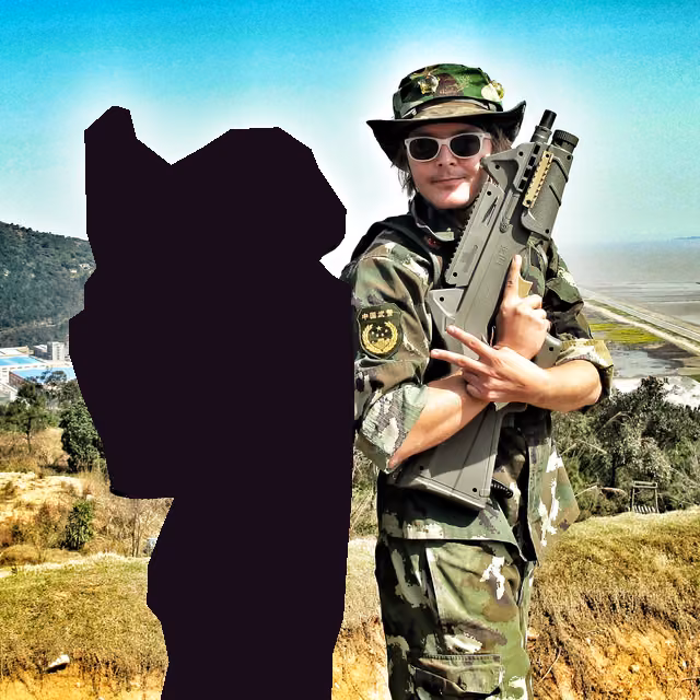 In camo with a laser-tag gun on a hilltop, beside a teammate printed as a silhouette